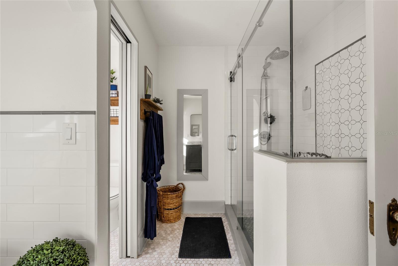 The spa-like primary bathroom boasts a double vanity, soaking tub, shower stall with built-in shelf and separate water closet.