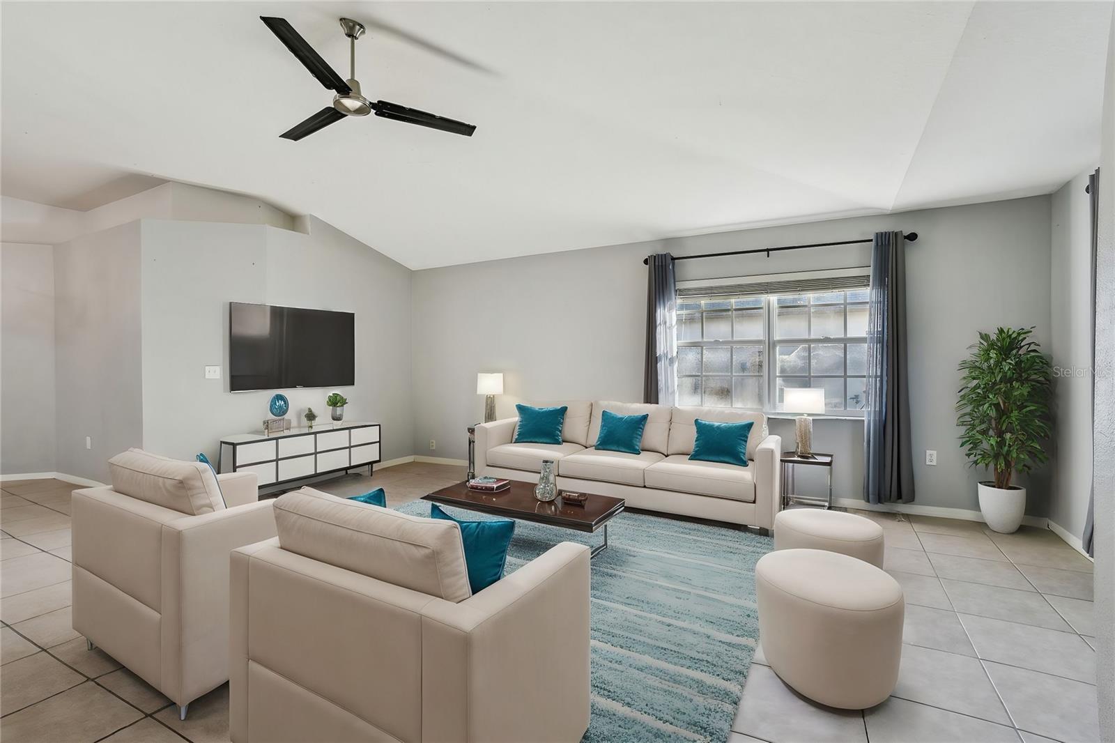 Living room has volume ceilings with open floor plan