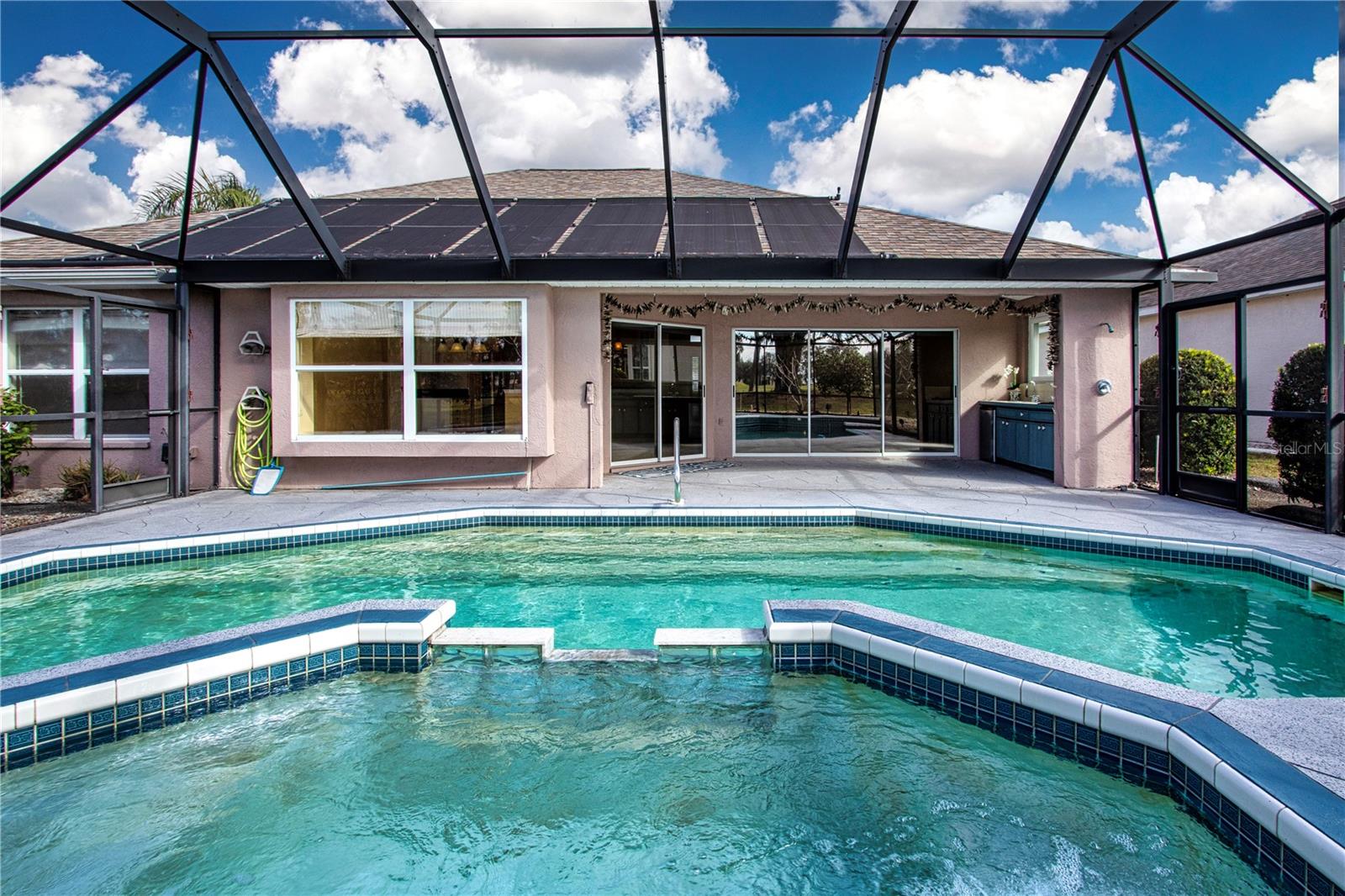 View from Spa of Covered Lanai, Outside Shower and Summer Kitchen