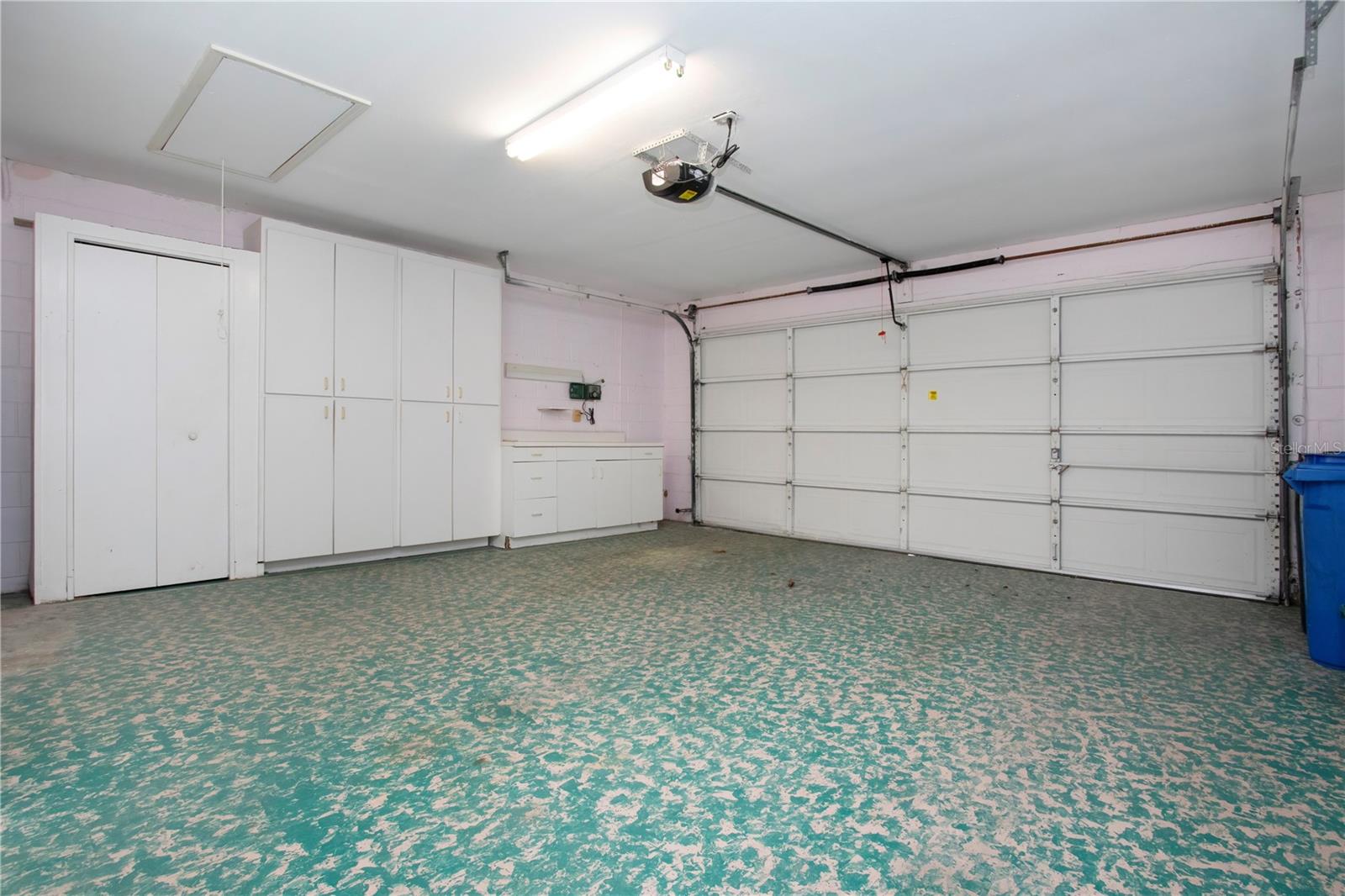 Large 2 car garage w/work space & storage cabinets