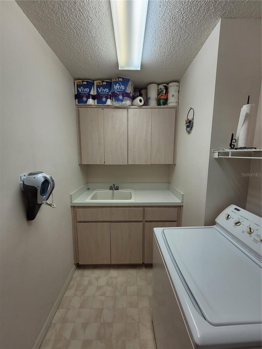 nice size laundry room with utility sink