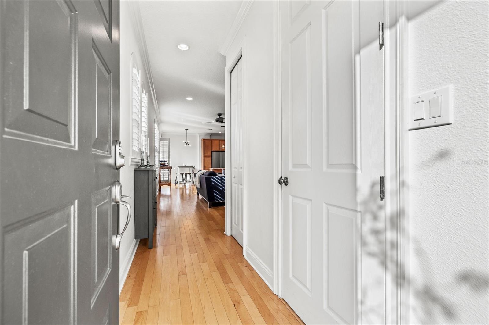 Entryway with powder bath and storage closet pictured.