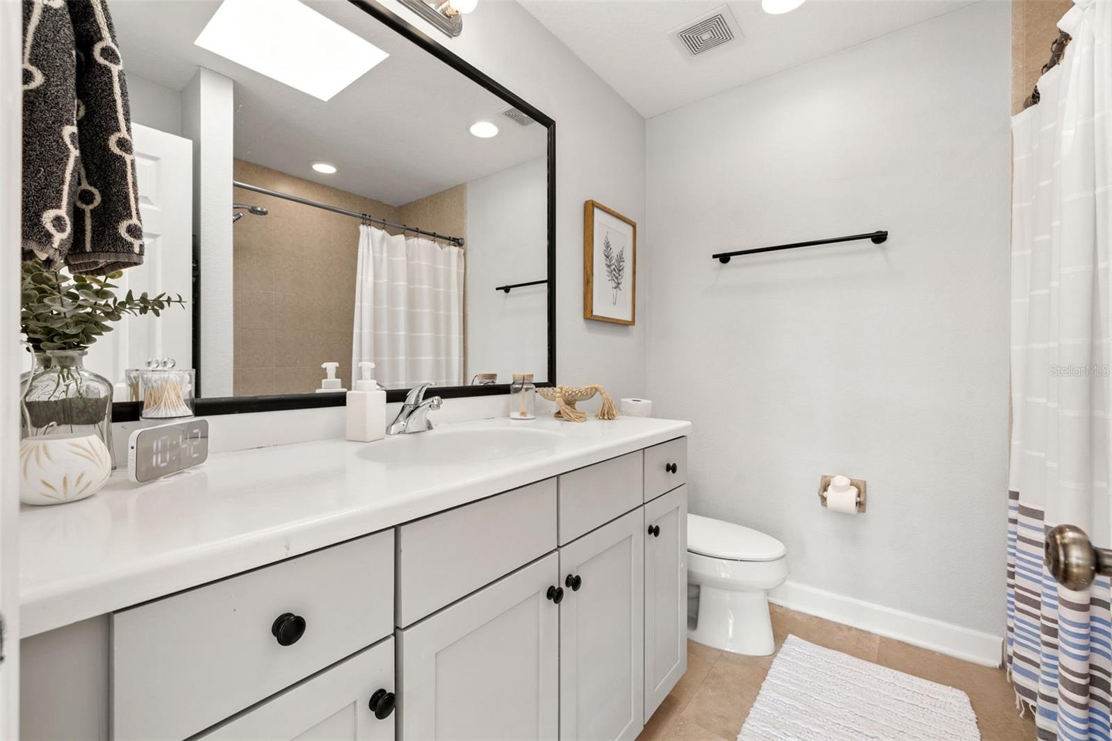 Upstairs Guest Bathroom with Shower/Tub Combo and Skylight