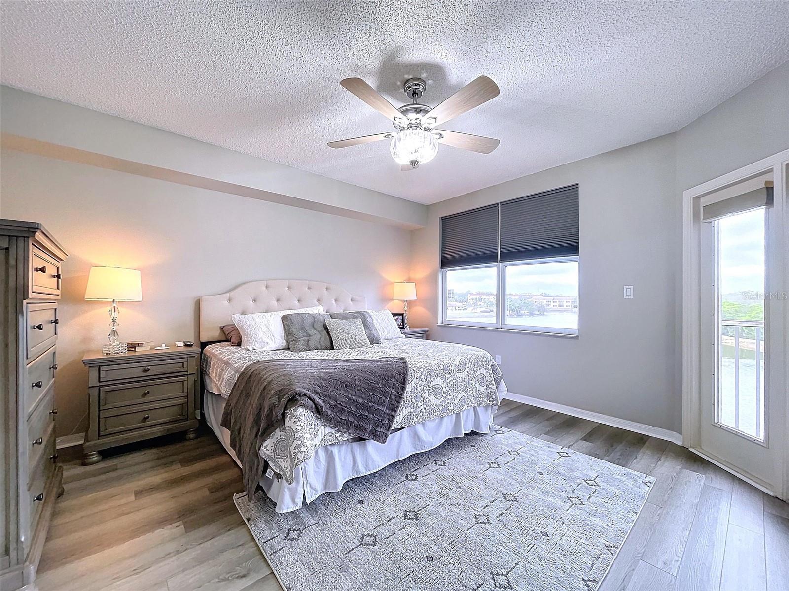 The Primary bedroom offers its own balcony access through French doors as well as plenty of natural lighting.