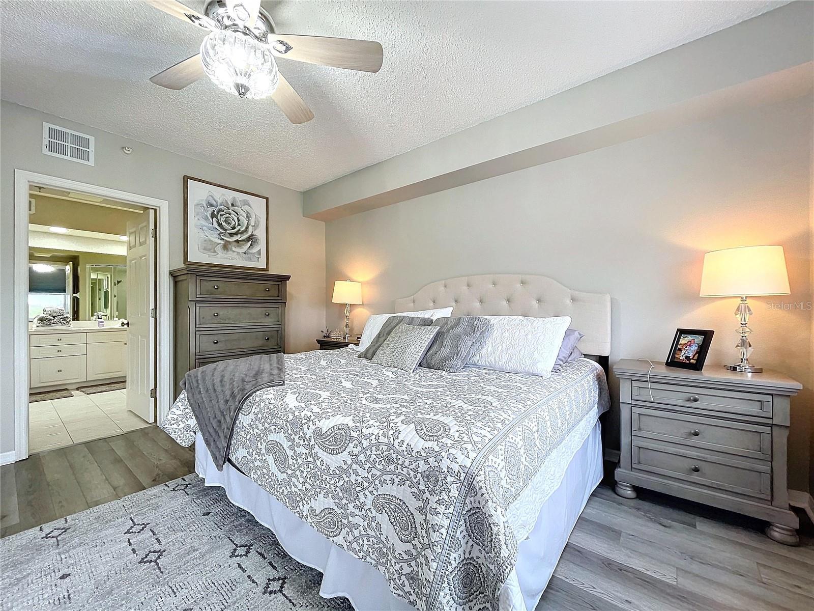 The Primary bedroom offers its own balcony access through French doors as well as plenty of natural lighting.