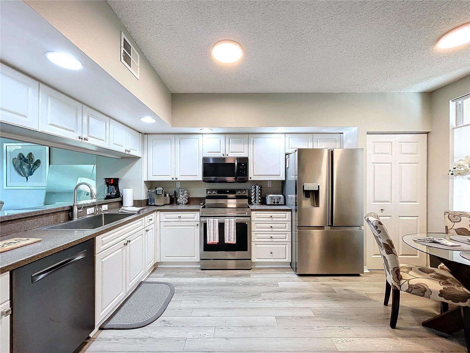 Kitchen features a closet pantry and breakfast table space.