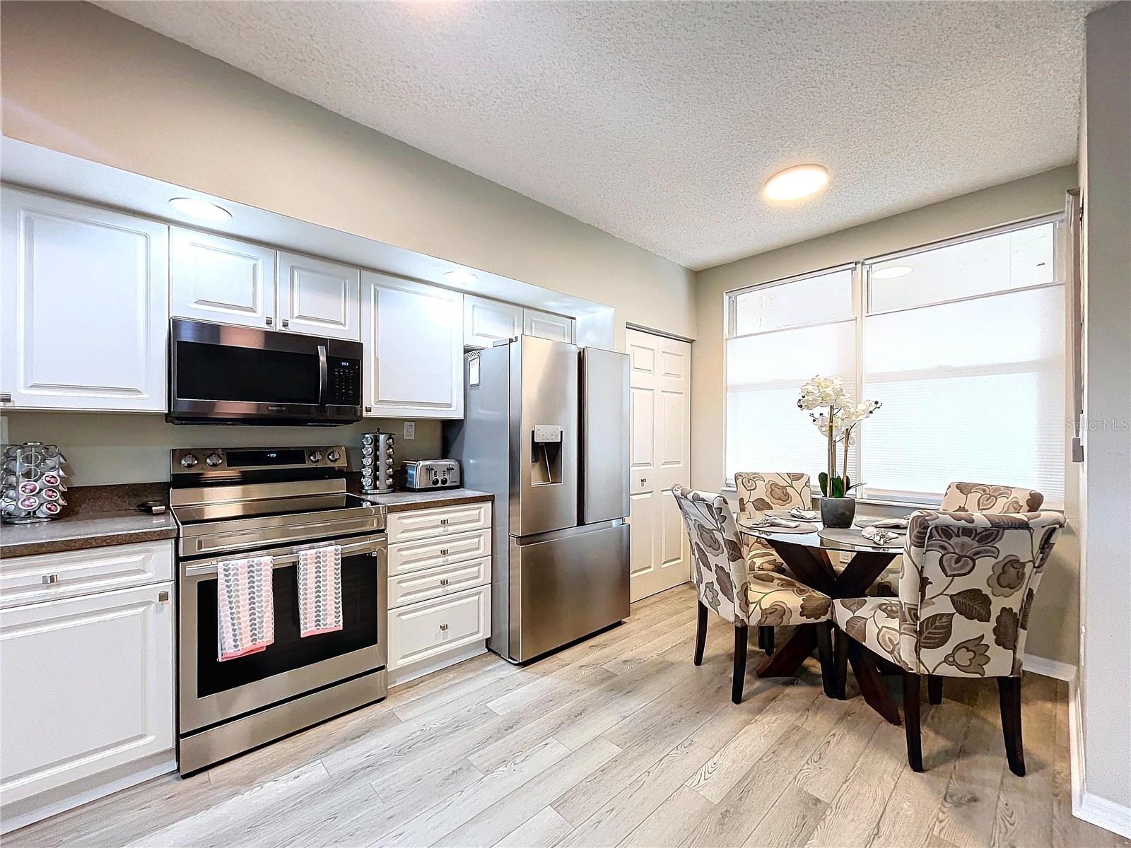 Kitchen features a closet pantry and breakfast table space.