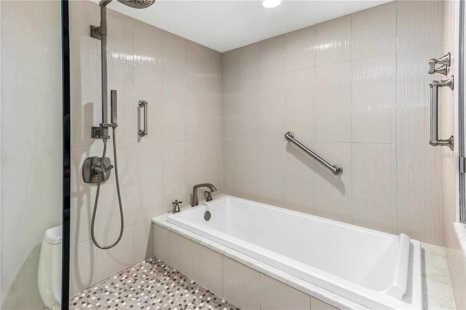 UNIQUE SHOWER AND BATHTUB COMBO IN PRIMARY BATHROOM