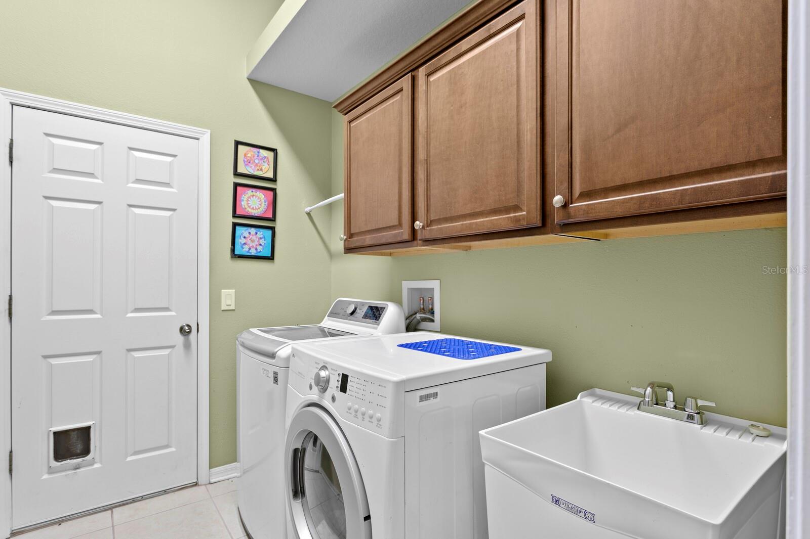 Inside utility room with cabinet storage and new utility sink