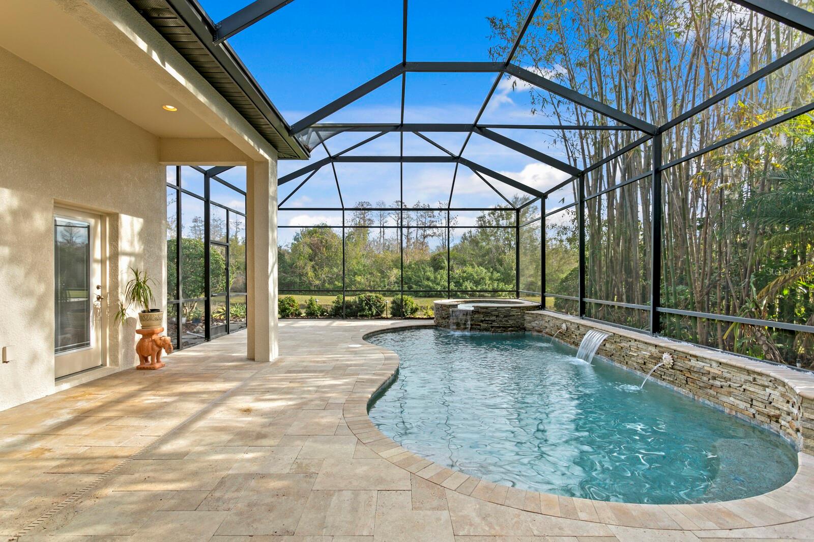 Beautiful travertine deck alongside the custom pool