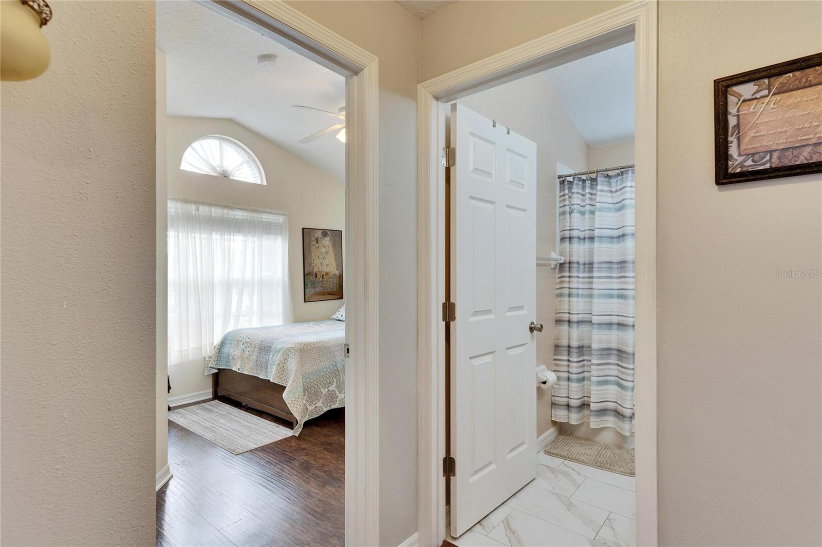 hallway to the 2 bedrooms with a bathroom in the middle