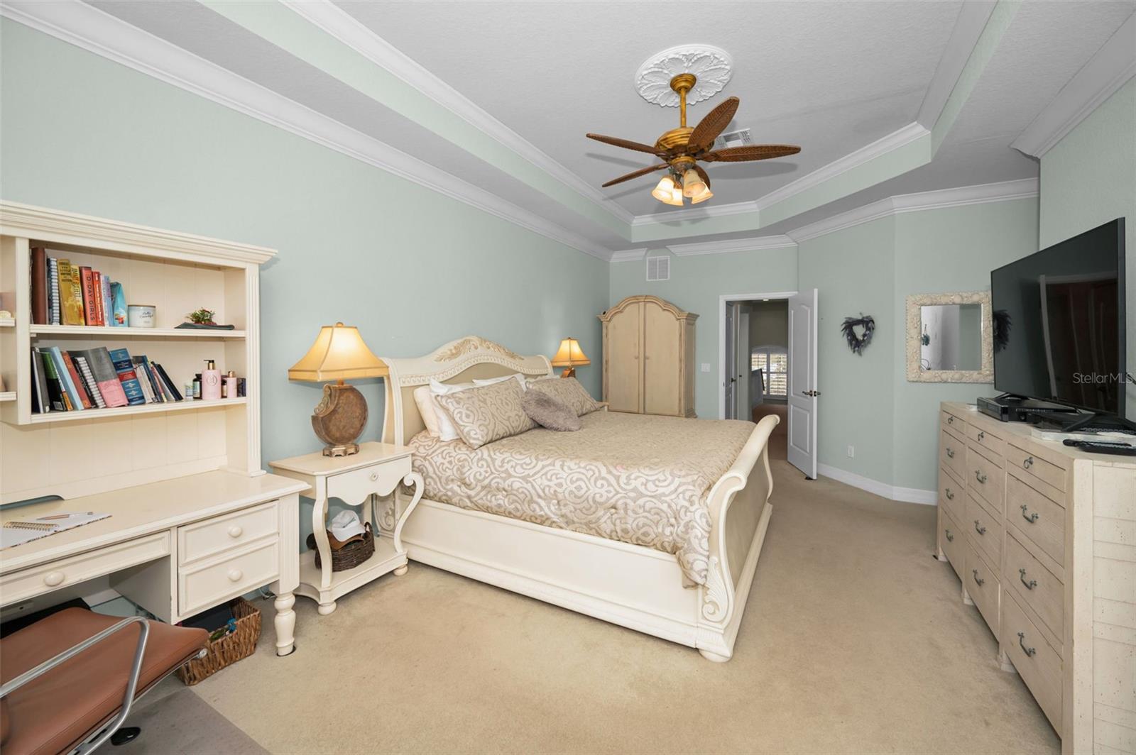 Primary Bedroom is so roomy with a magnificent crown molding & tray ceiling