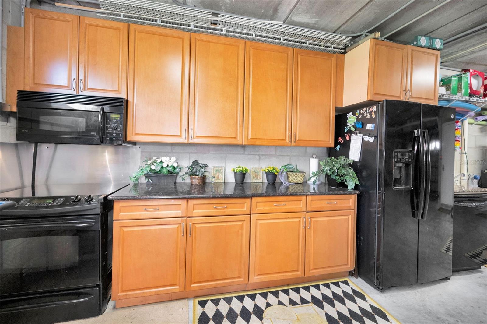 Entry Level Kitchen in Garage Cabinet packed with all appliances including Dishwasher, for easy entertaining by the grill & after a swim by the pool, just steps away