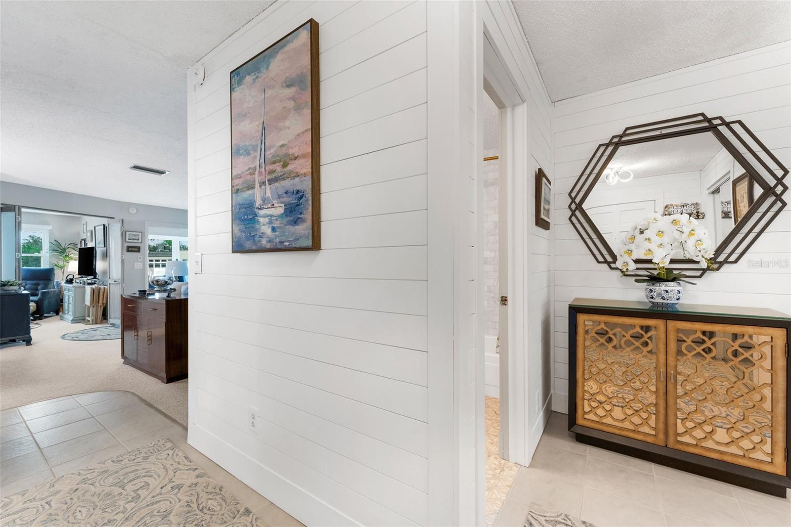 Entry way with Hall Bath and 2 bedrooms to Right and living Areas and kitchen to the Left.