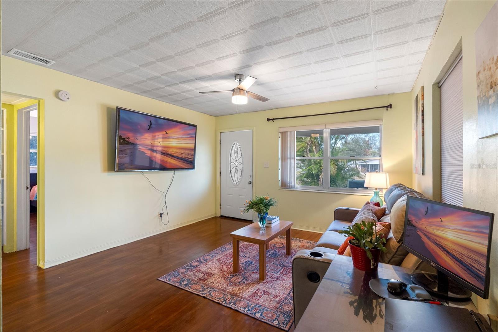 Step into a cozy living space with beautiful hardwood floors and a bright, open-concept layout