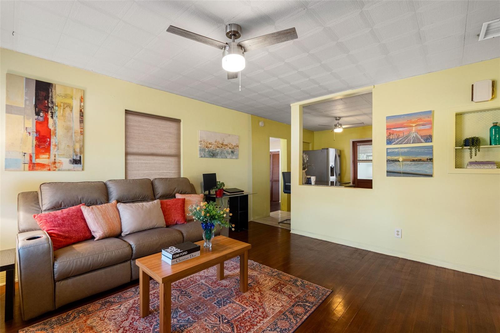 Step into a cozy living space with beautiful hardwood floors and a bright, open-concept layout