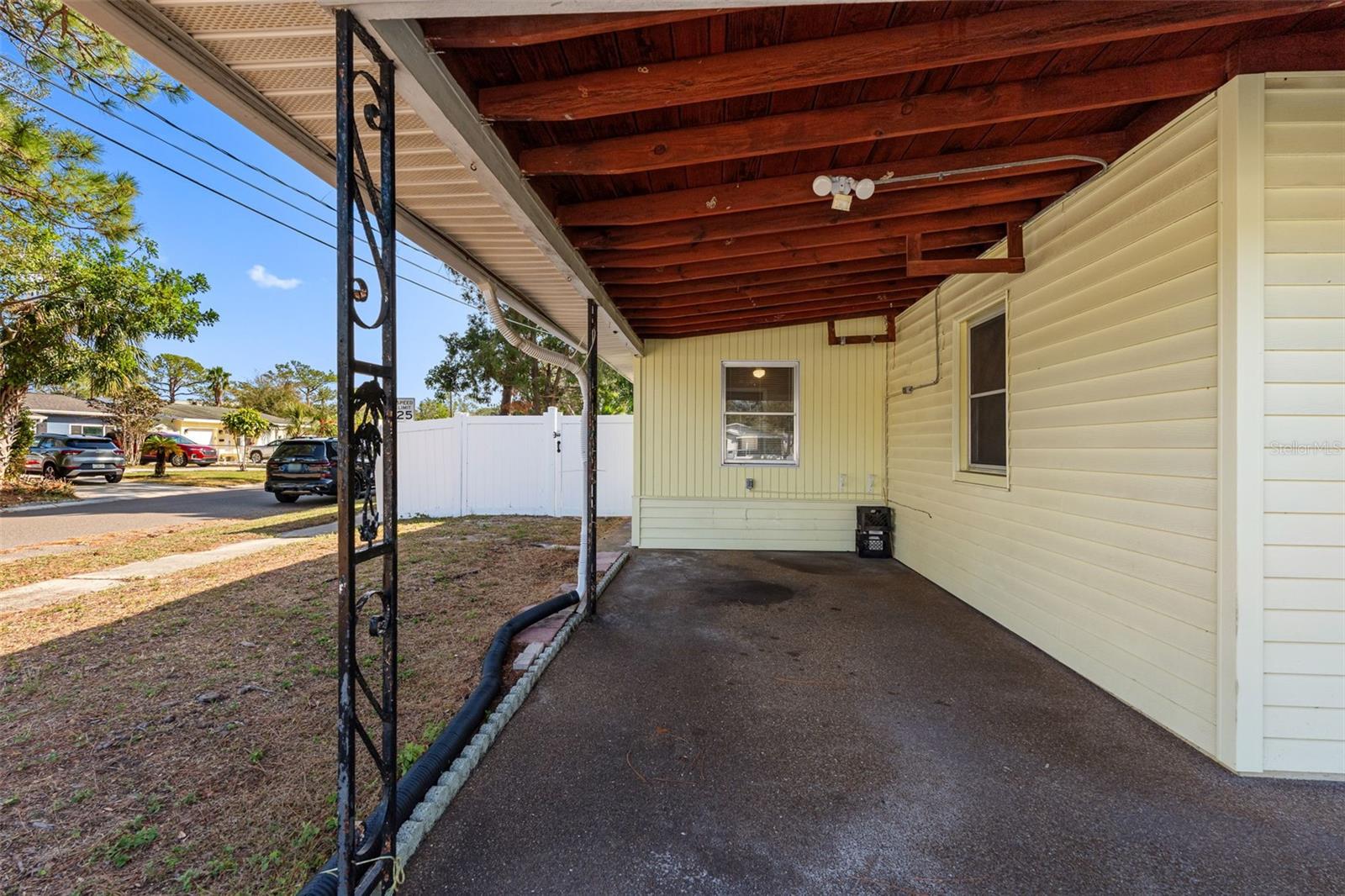 Practical and charming—a carport for covered parking and easy access to the home.