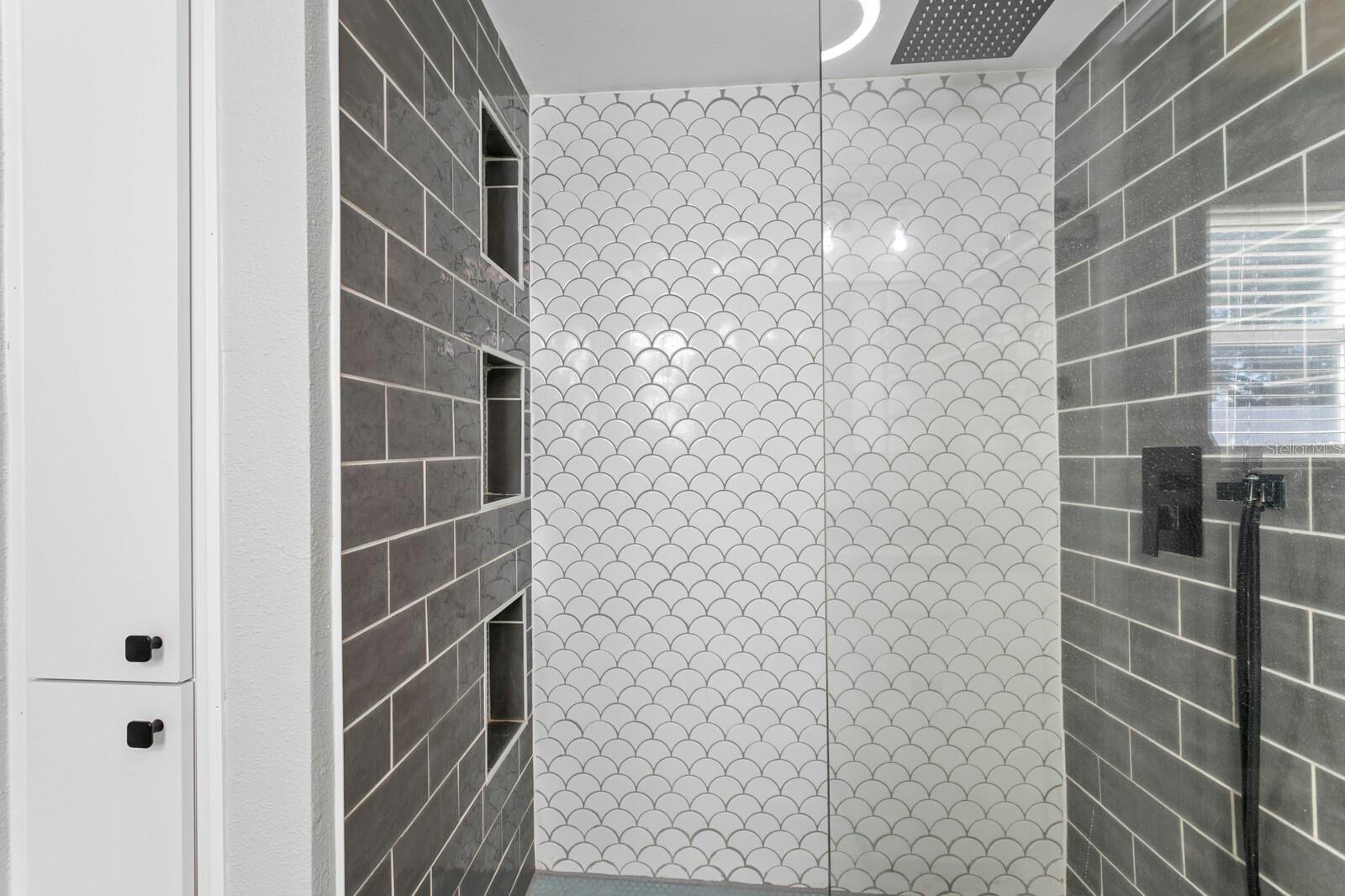 Beautiful porcelain tile work in the primary walk-in-shower