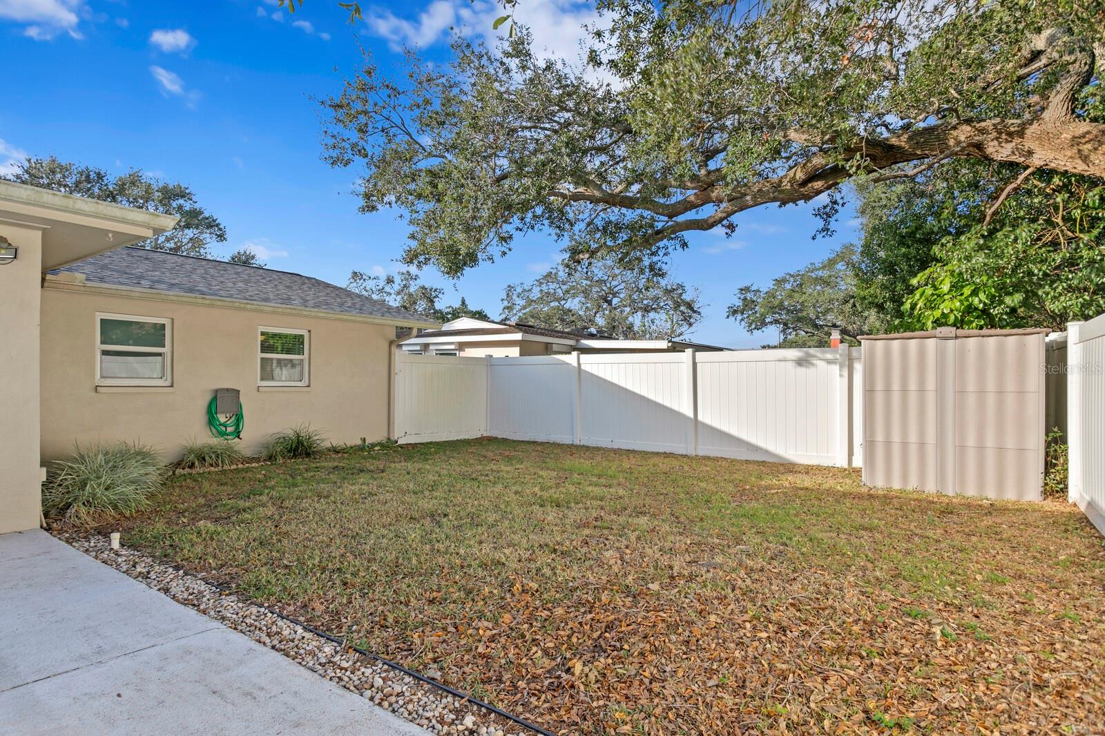 Large, fully fenced backyard and storage shed