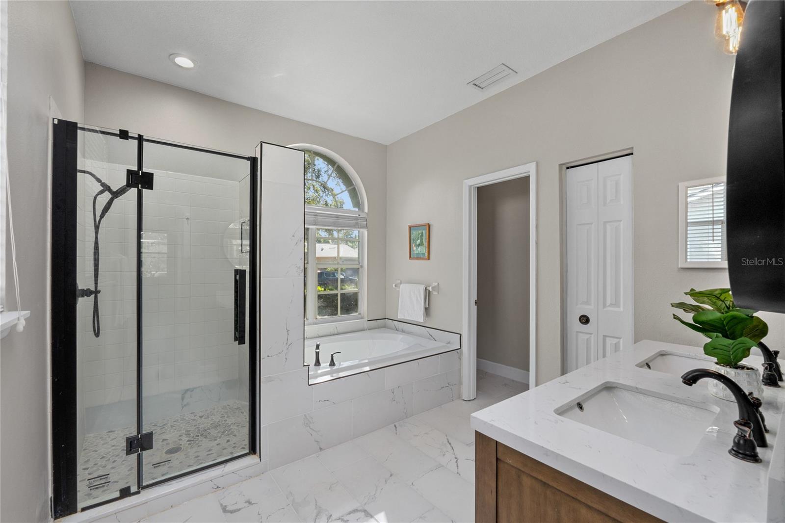 Fully Updated in 2023, this Primary Bathroom is a dream with NEW Tile, Shower, Tub, Countertops, lighting...