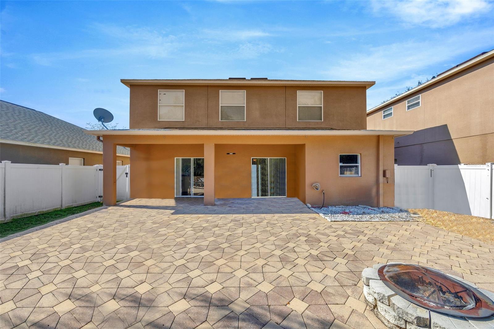 Back of home, paved patio & yard space