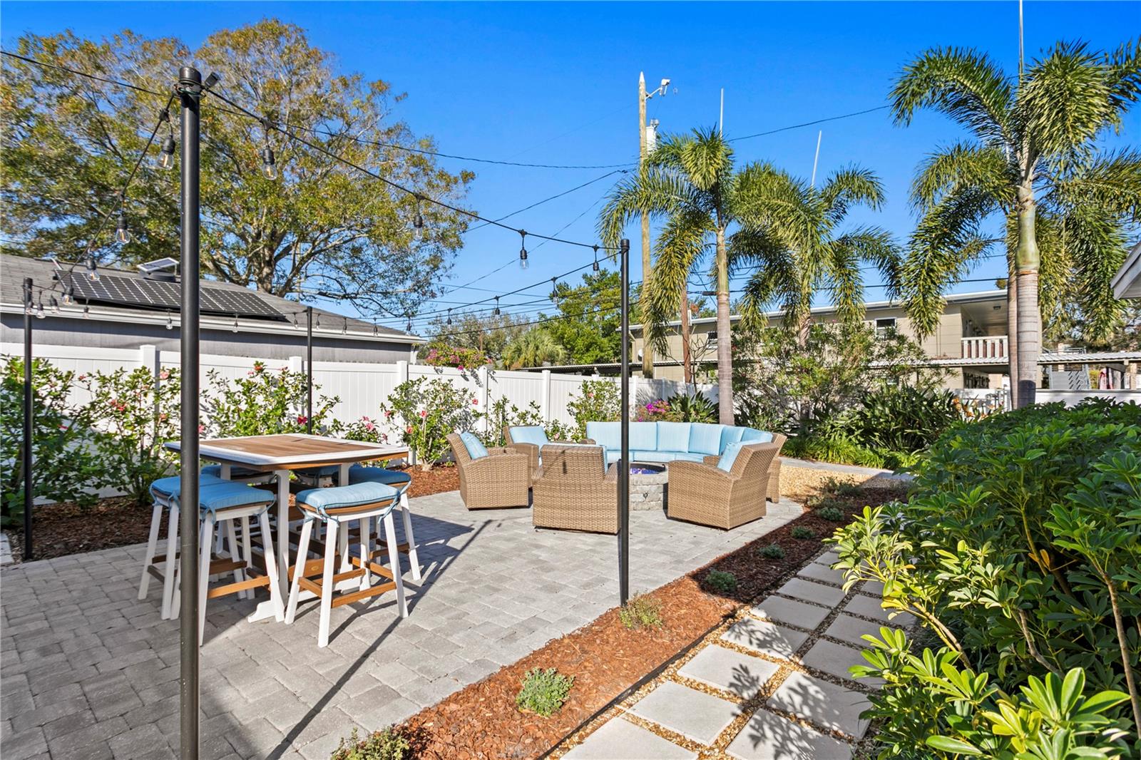 Beautifully landscaped yard with paver patio and lighting