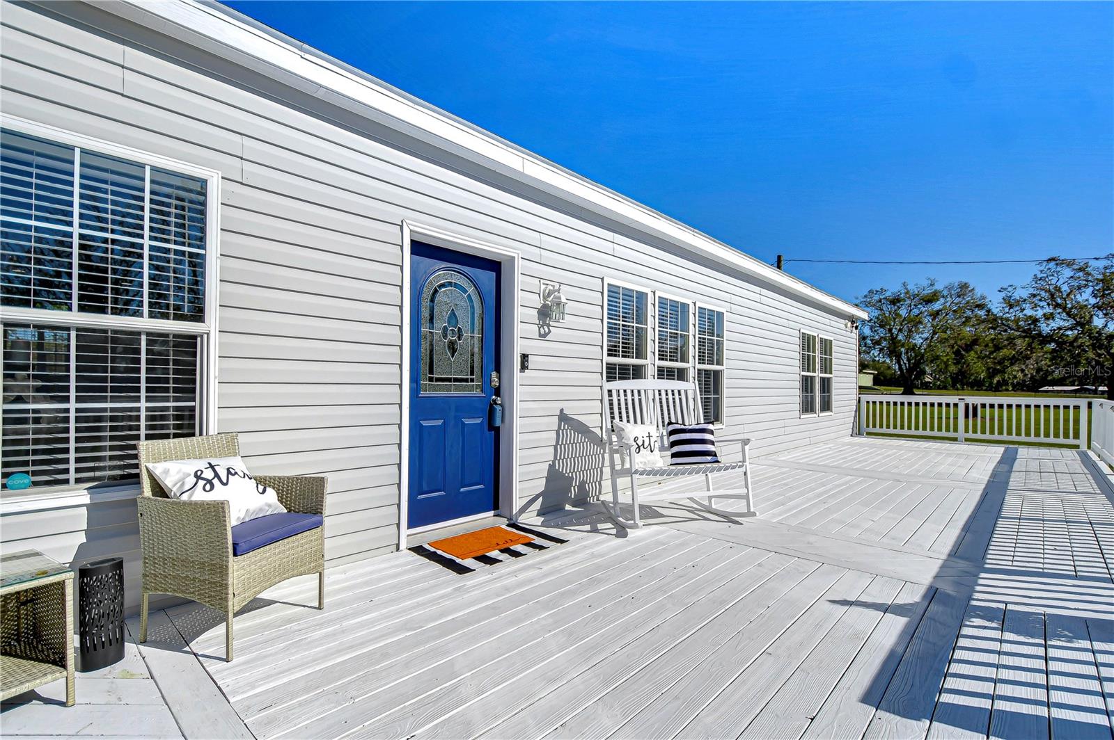 Imagine sipping your coffee on this oversized front porch!