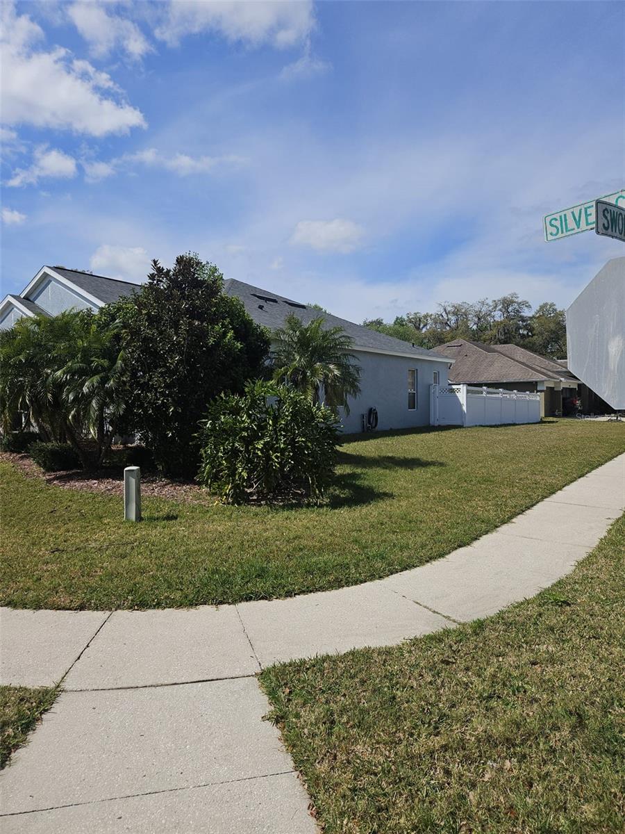 This home is located on a corner lot.  As you go around the corner, the home is shield from view which gives it a nice a appearance.  To the far-right rear you see the vinyl fence.  The lot is completly fenced in.