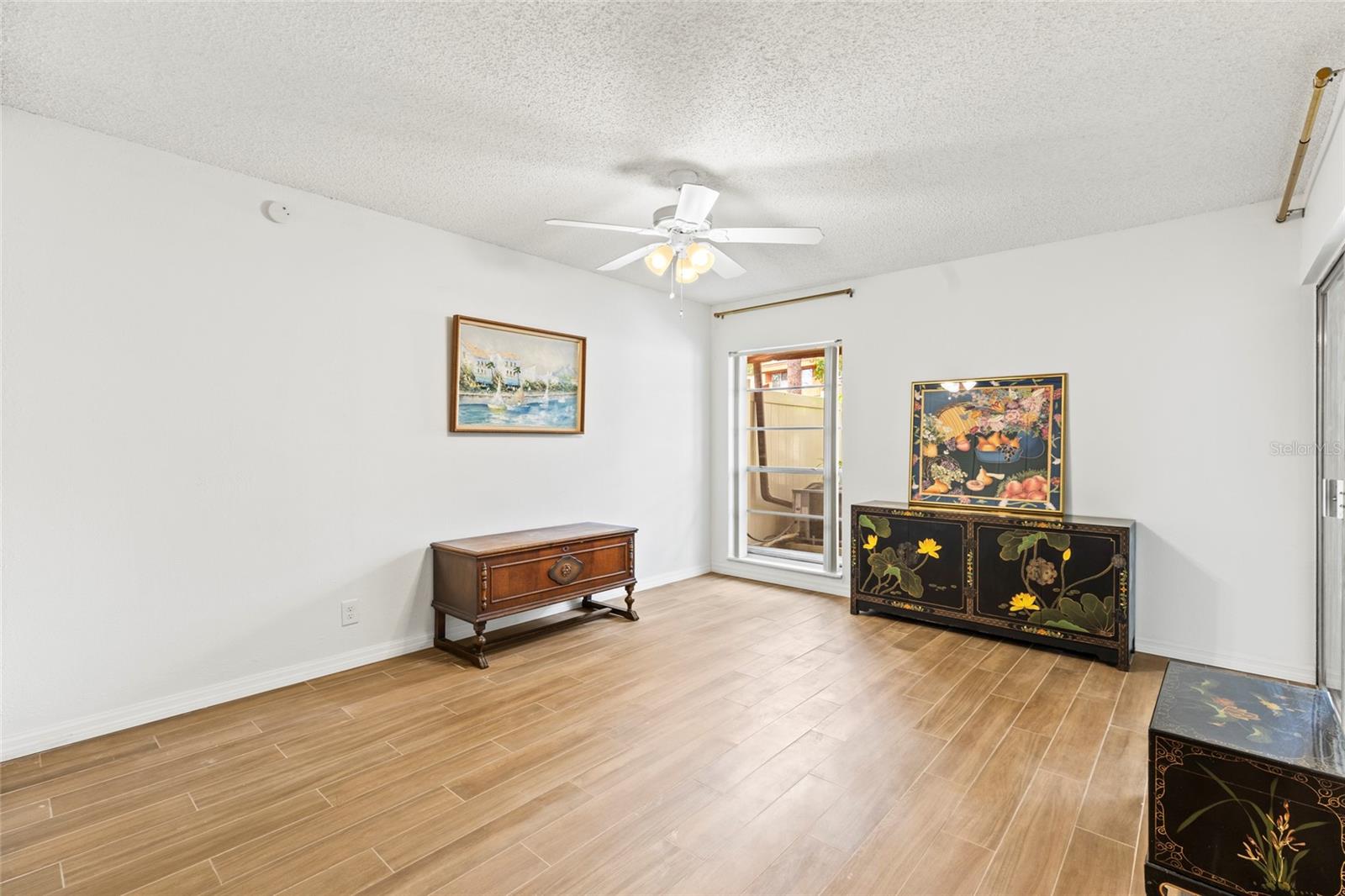 Primary bedroom looks out into the garden and has a sliding glass door with direct access to the covered patio.