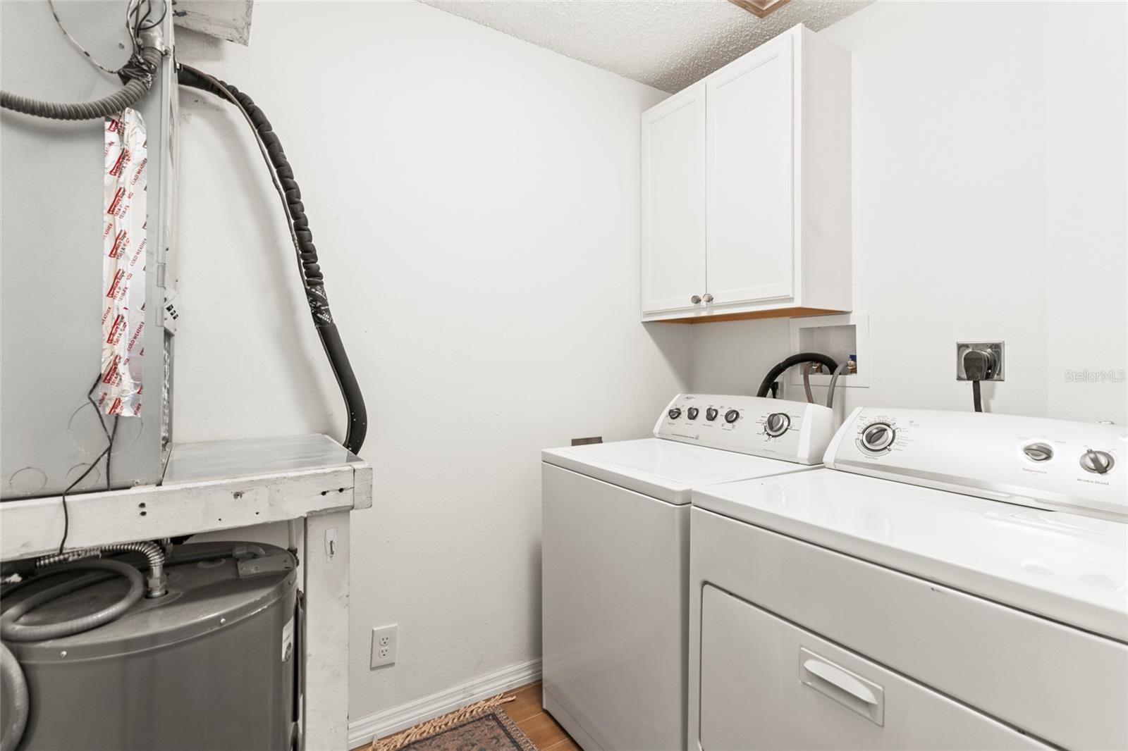 Walk-in laundry room with full size washer and dryer purchased in 2023.