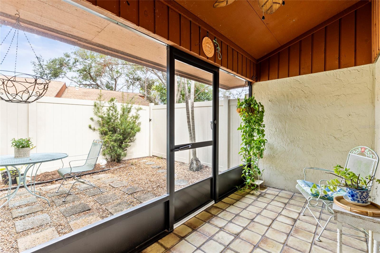 Enclosed outdoor patio has a ceiling fan as well.