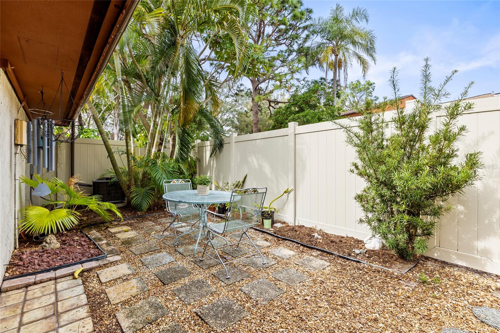 Outside garden large enough for a grill, dining table and gardening. New vinyl fencing was installed in 2023.