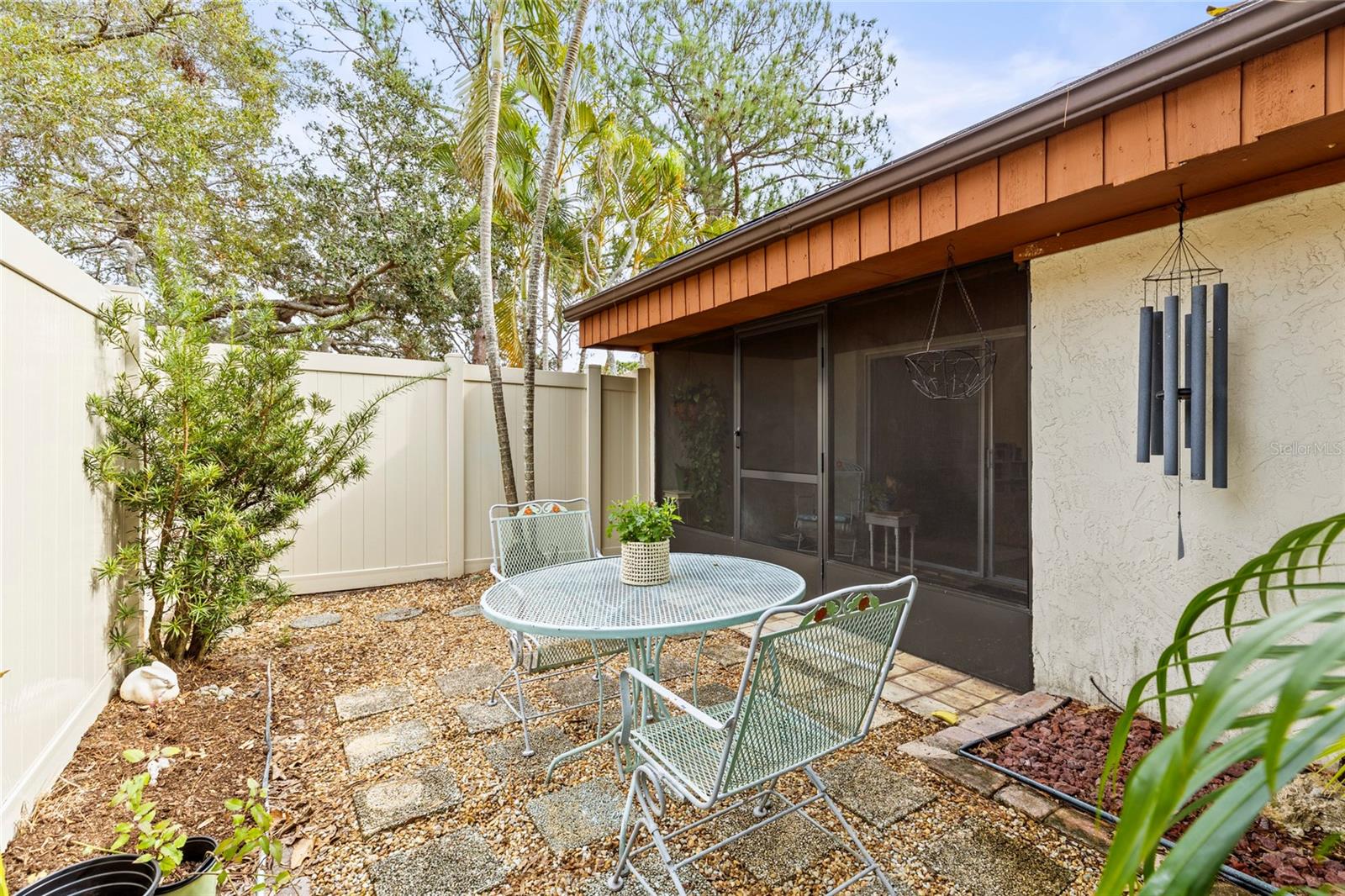 Another view of outside yard. There is a gate in the vinyl fencing which allows you direct access outside. It can be locked from inside.