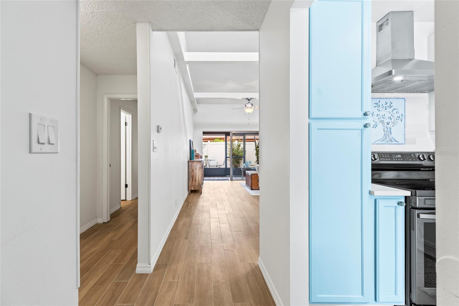 View walking into the home. Kitchen is to the right, hallway to bedrooms and bathrooms is to the left.