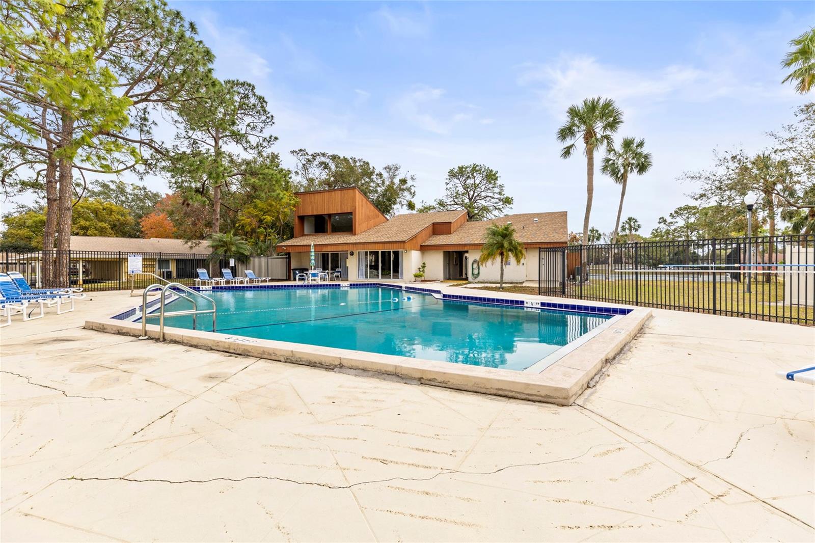 Community pool with a view of the attached clubhouse.