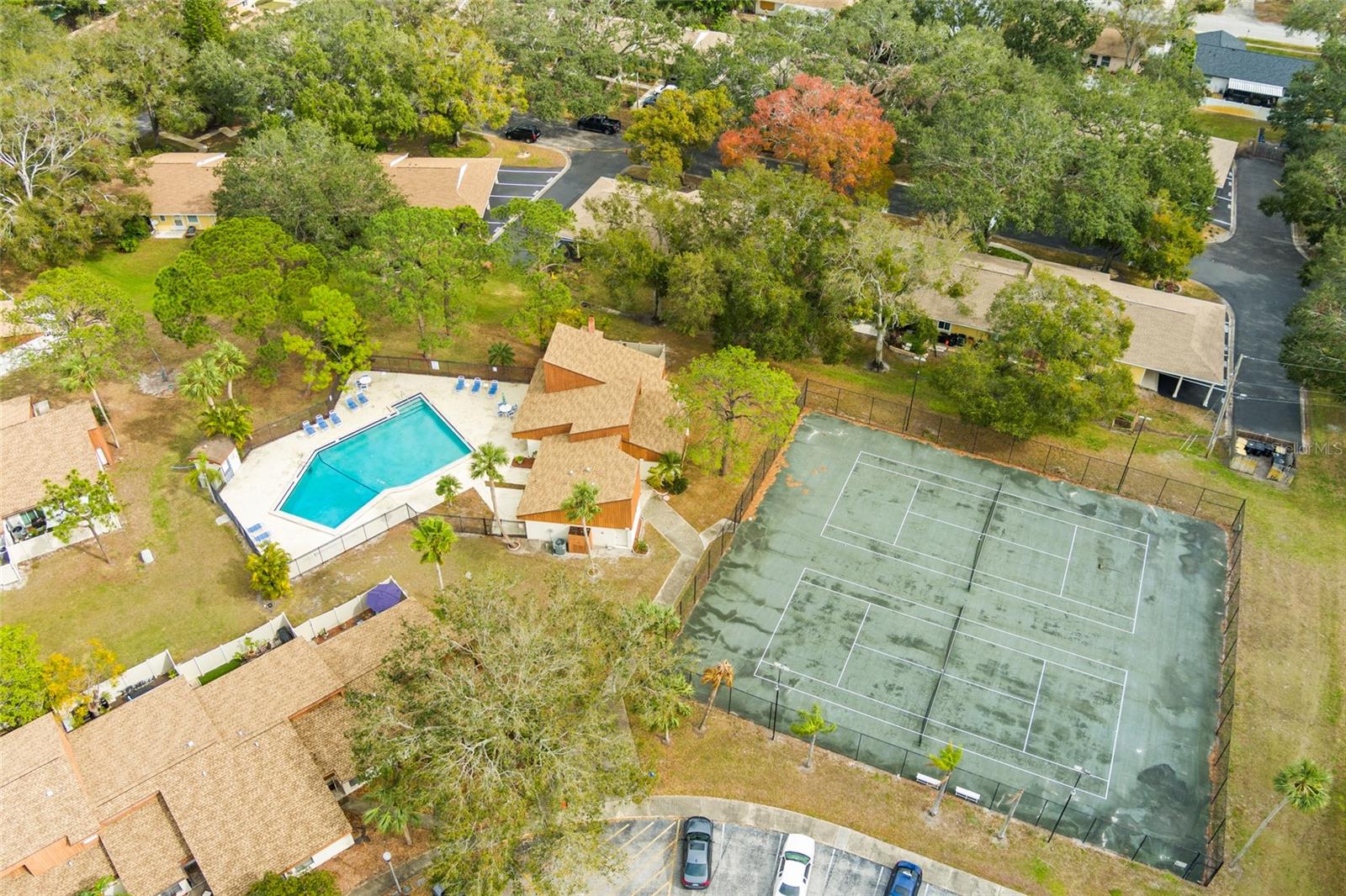 Ariel view of community pool, clubhouse and tennis courts. Lots of areas for animals and kids to play.