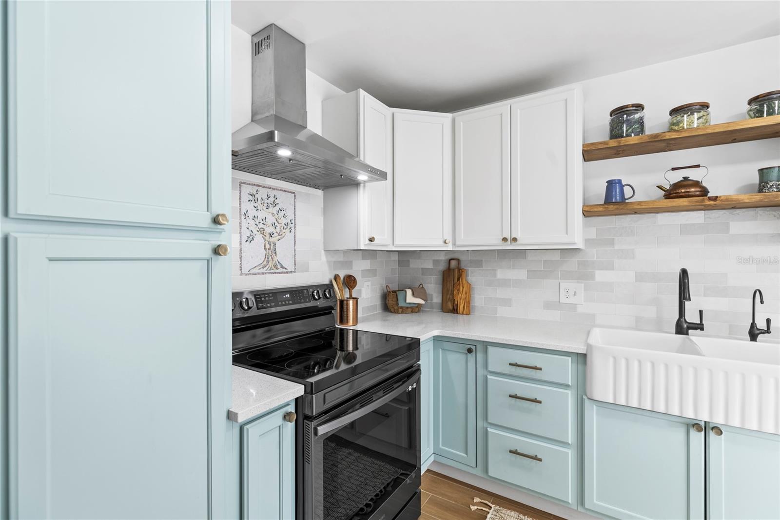 Lower corner cabinet has a built in Lazy Suzan with lots of storage and easy access. Custom inlaid mosaic above the stove.