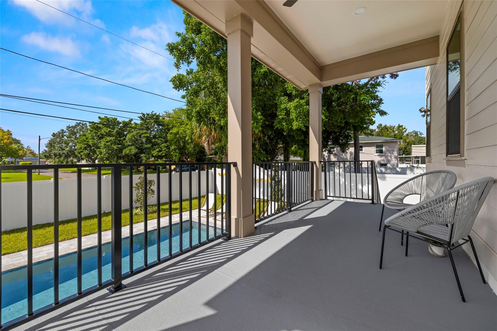 back porch overlooking swimming pool with staging