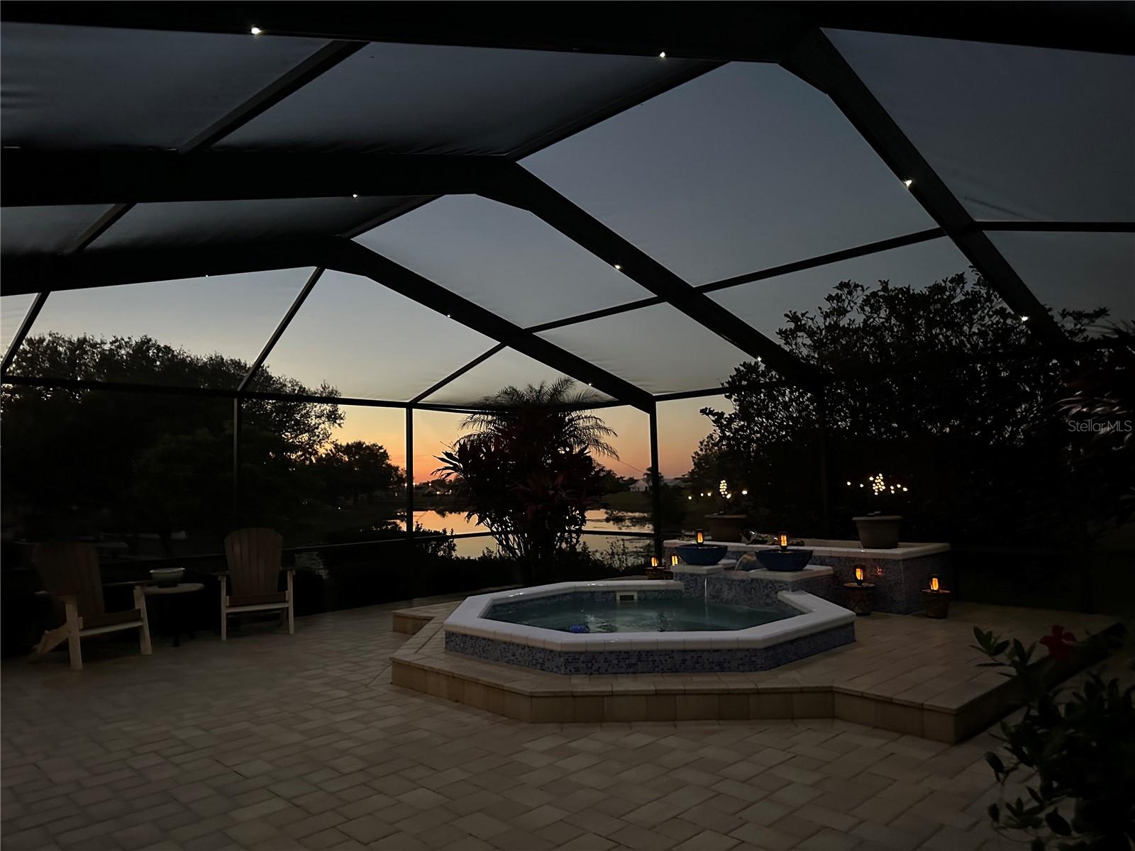 Sunset w/ Fabulous Outdoor Living Space with Waterfall feature & Nebula Cage Lighting