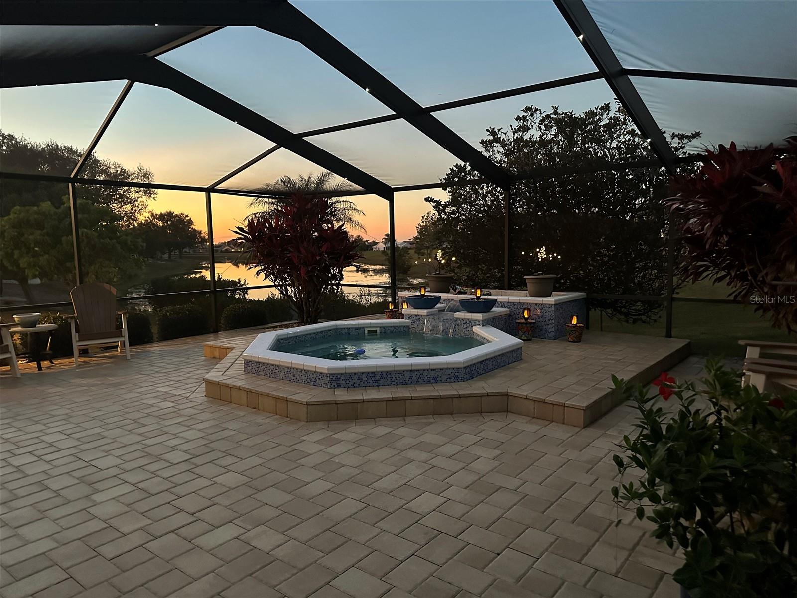 Sunset w/ Fabulous Outdoor Living Space with Waterfall feature & Nebula Cage Lighting