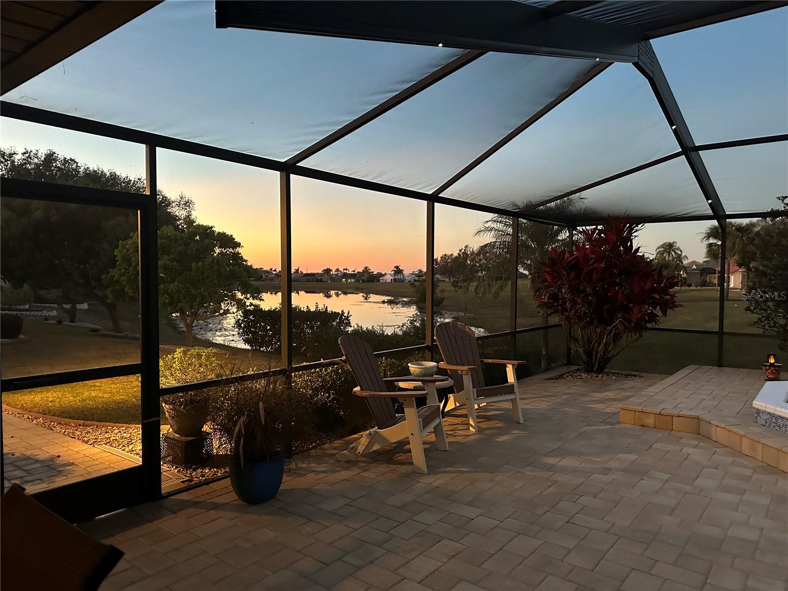 Sunset w/ Fabulous Outdoor Living Space with Waterfall feature & Nebula Cage Lighting