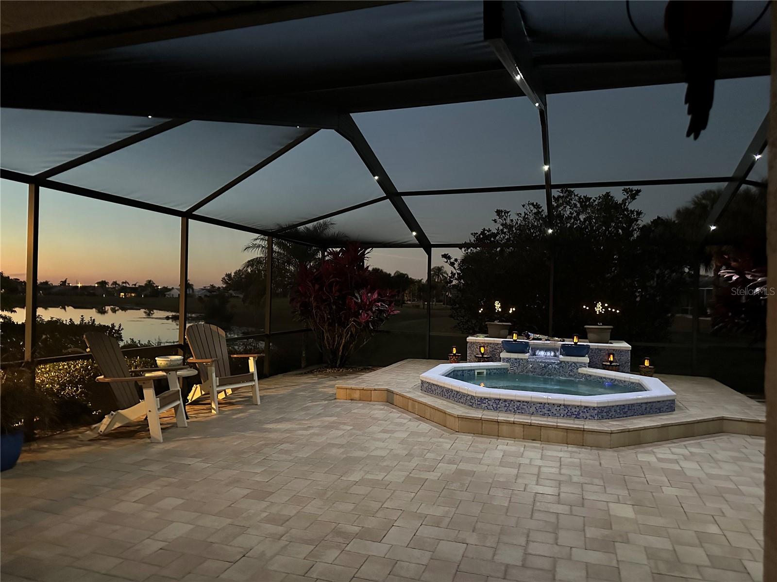 Sunset w/ Fabulous Outdoor Living Space with Waterfall feature & Nebula Cage Lighting