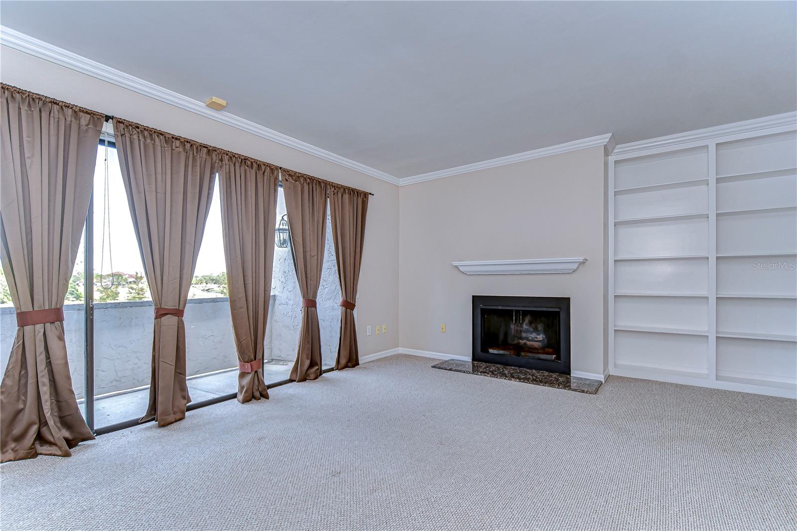 Primary bedroom with fireplace and built-in bookshelves