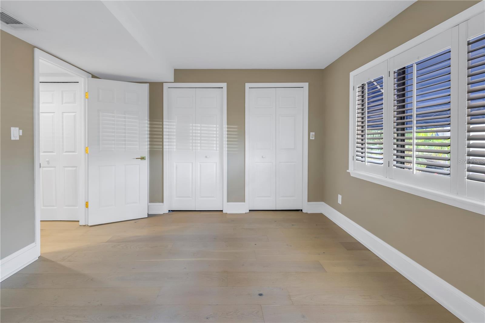 Second bedroom with plenty of closets and updated doors