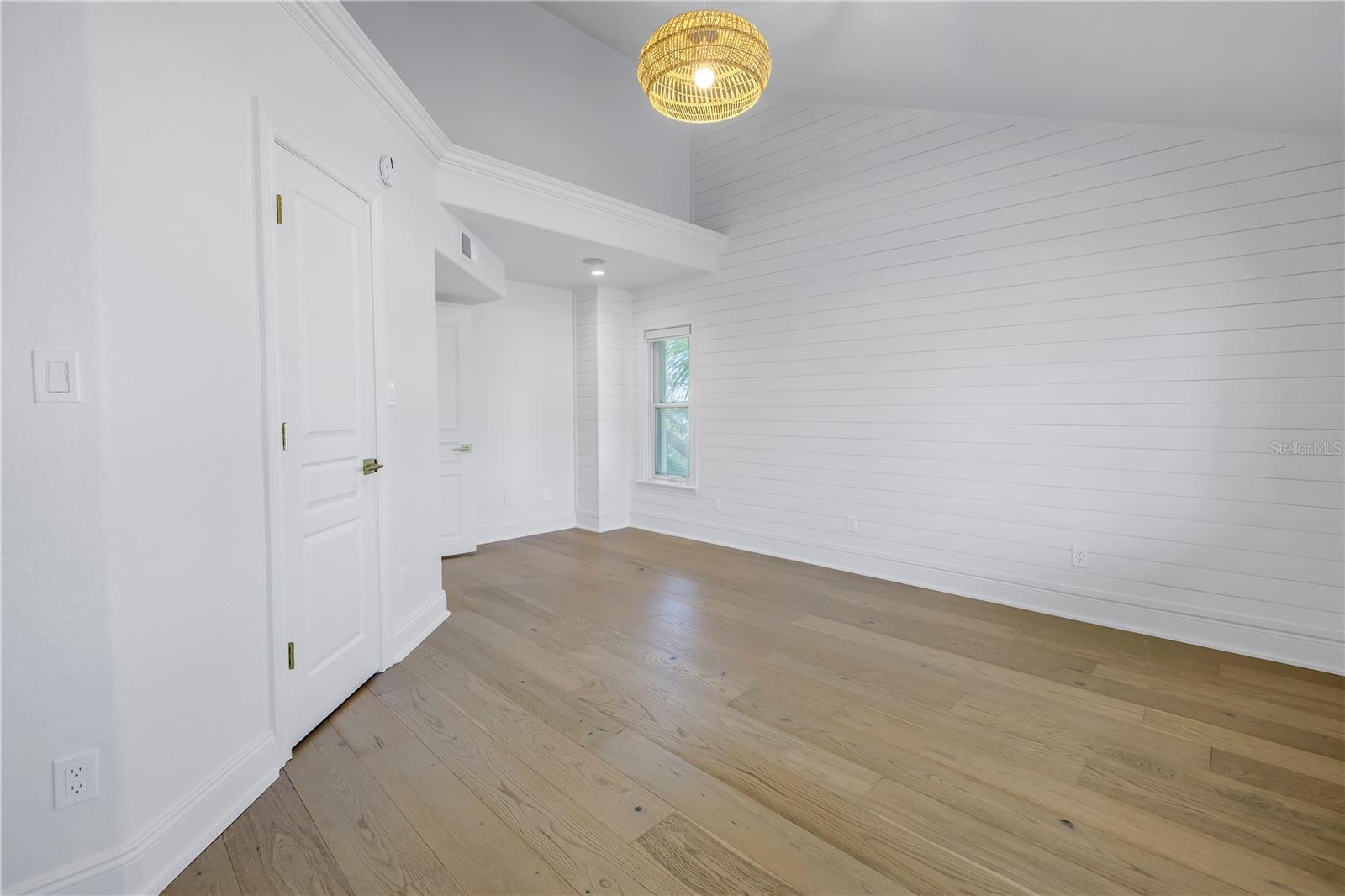 Primary bedroom has a focal shiplap wall