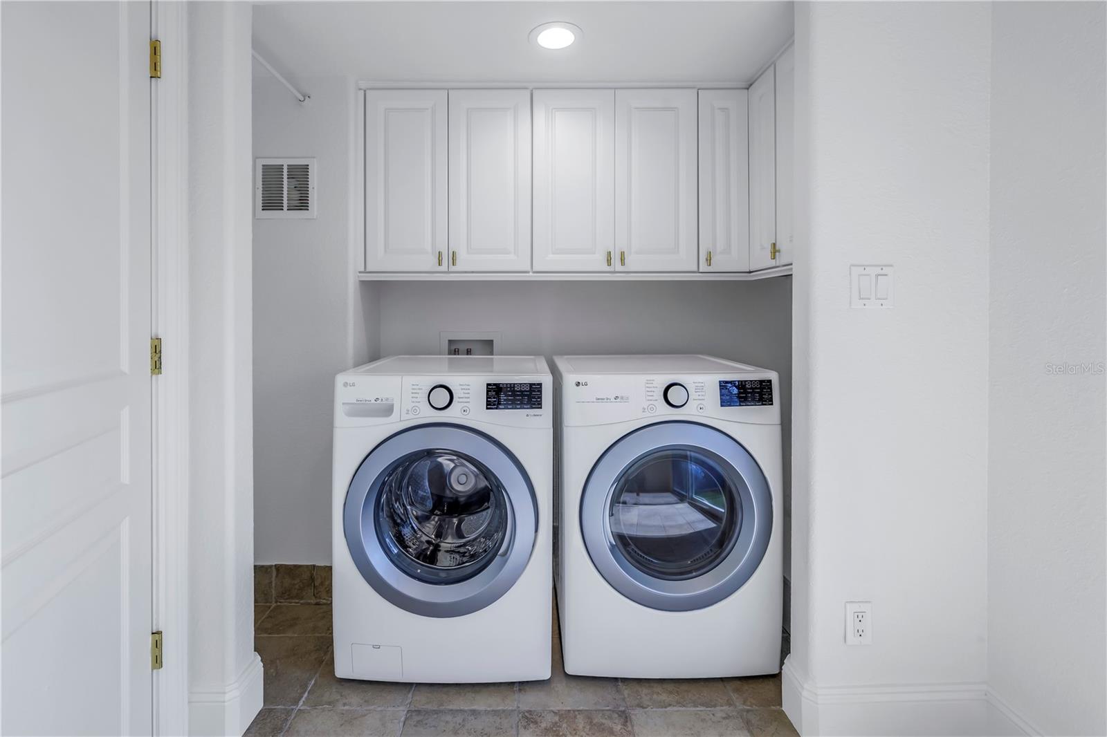 Laundry room is on this level with full size washer and dryer and cabinets for storage