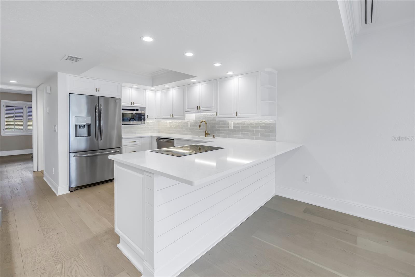 Bright kitchen with breakfast bar open to the living area