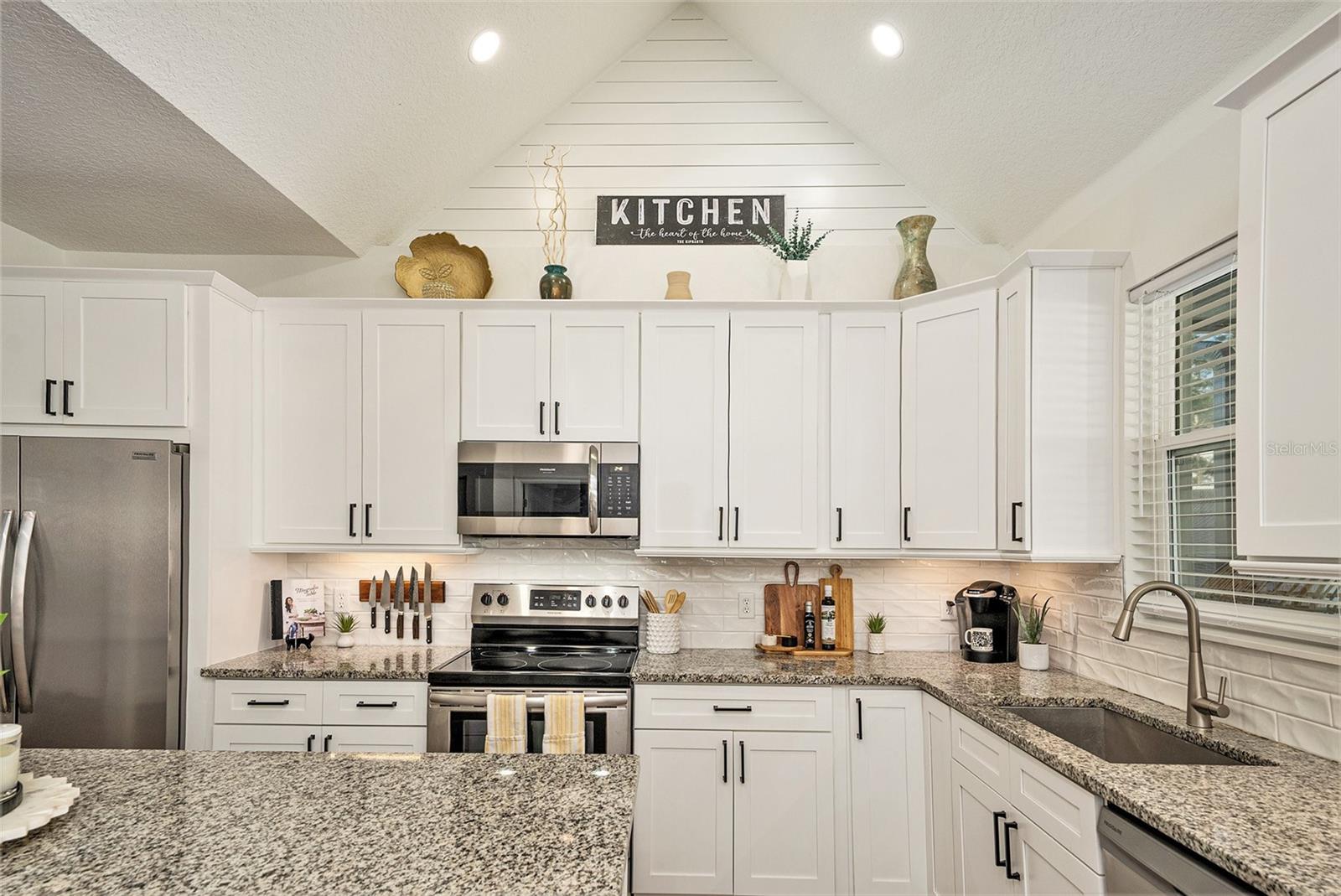 Expansive kitchen area with soaring ceilings