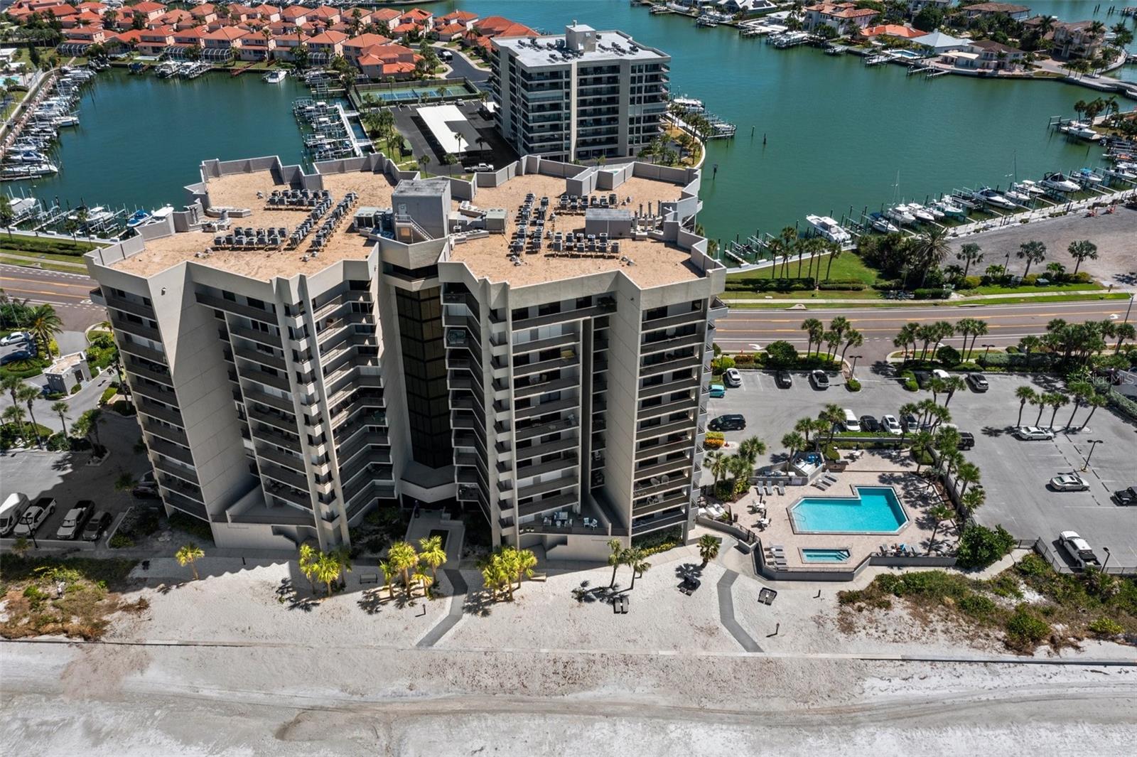 Condo building and pool with hot tub.