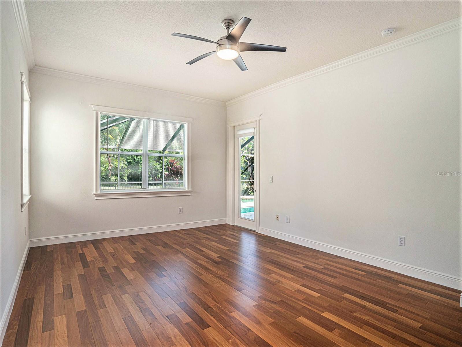 Master Bedroom with door leading out to Pool and Lanai